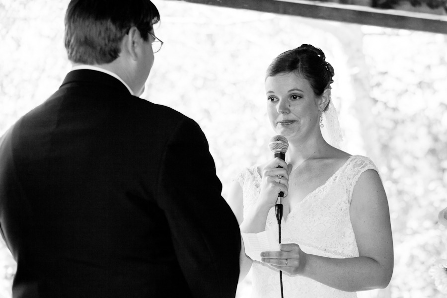 black and white photo of a bride holding a microphone and looking emotion