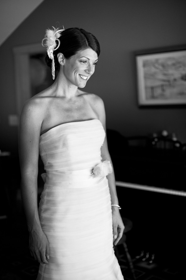 black and white photo of a bride looking at herself in the mirror