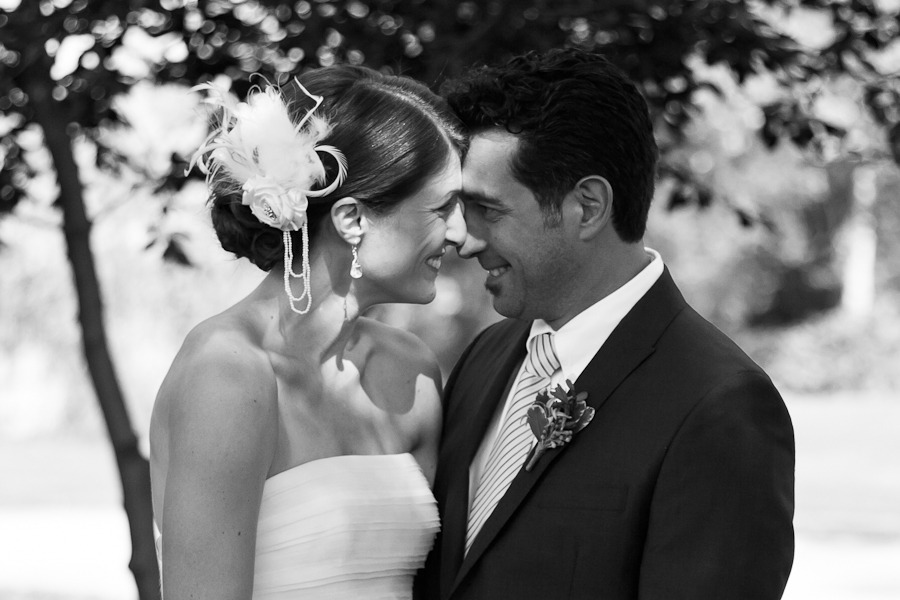 black and white photo of a bride and groom looking at each other and touching noses