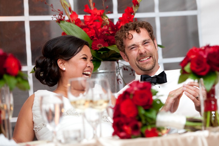 a seated bride and groom laugh