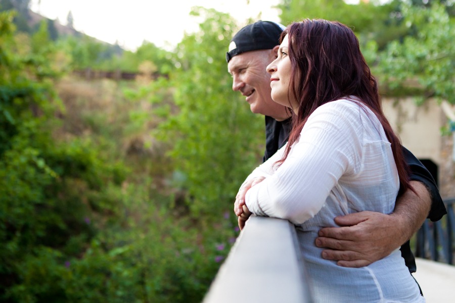 profile of a woman with red hair and a man who has his arm wrapped around the woman