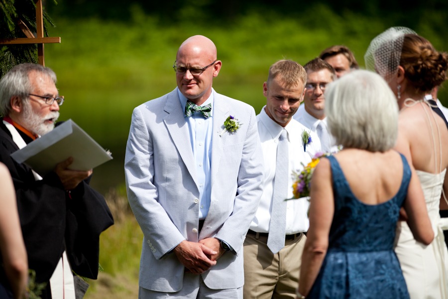 a groom looks at the officiant