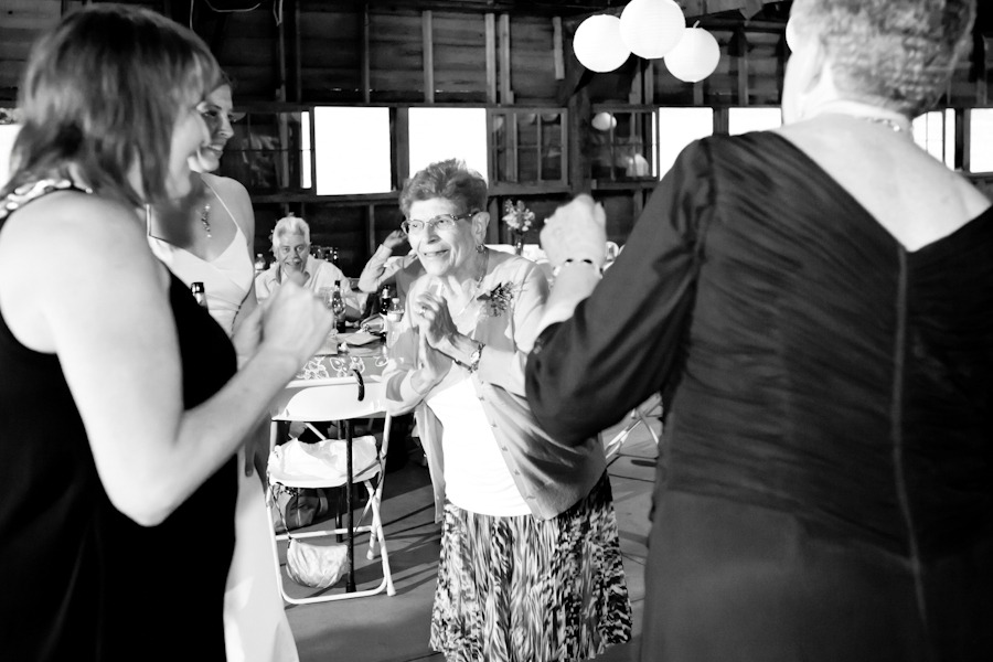black and white photo of a grandmother dancing at her grand-daughter's wedding reception