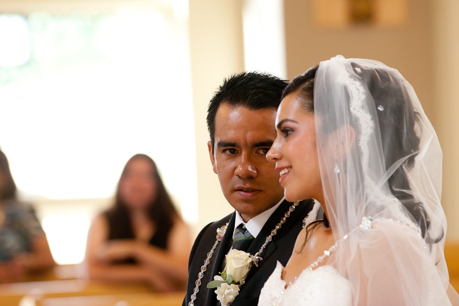 groom looks at a profile of his bride
