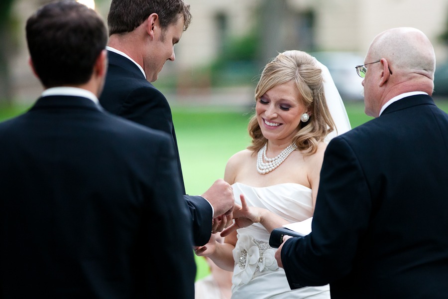 groom slides ring onto bride's finger
