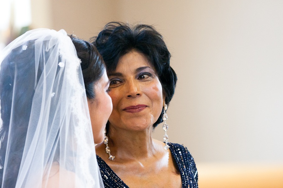 a mother looks at her beautiful daughter who is a bride