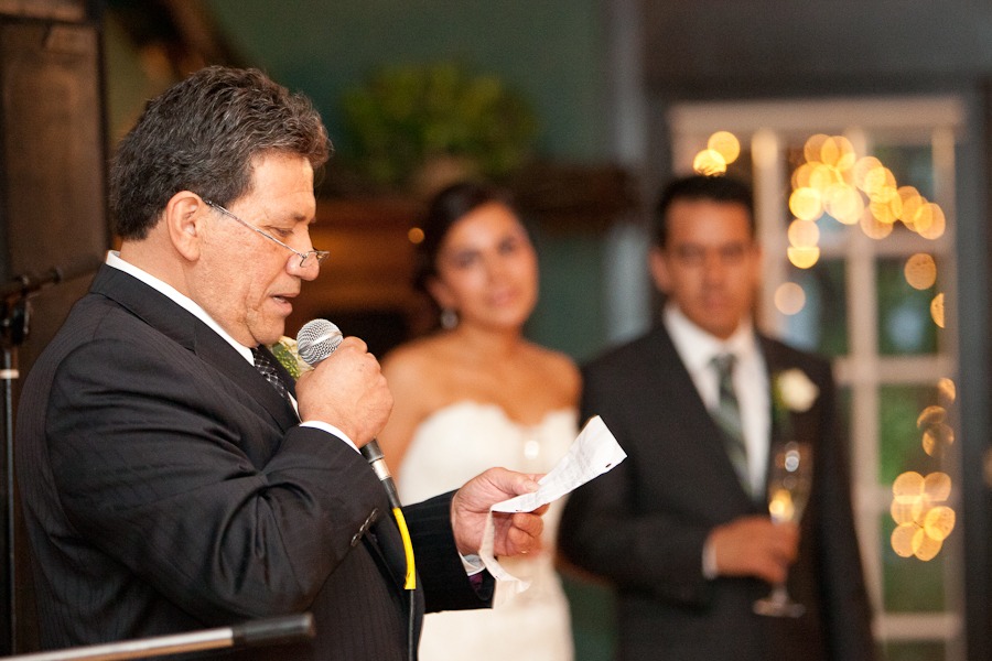 a father reads a speech in front of a bride and groom