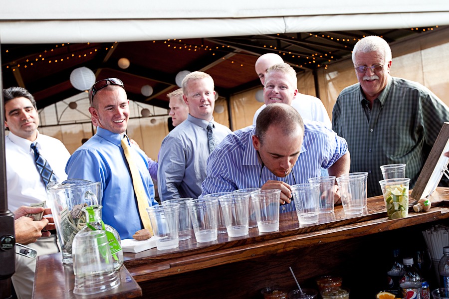 guys line up behind a bar to take a shot