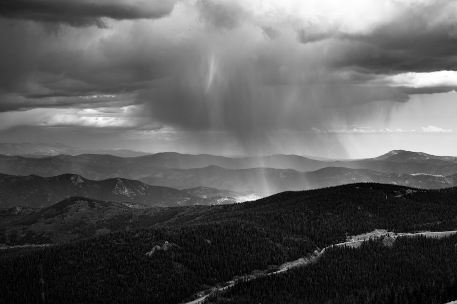 black and white landscape photo of rain and clouds in the mountains