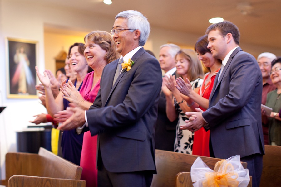 mom and dad clap after a wedding ceremony