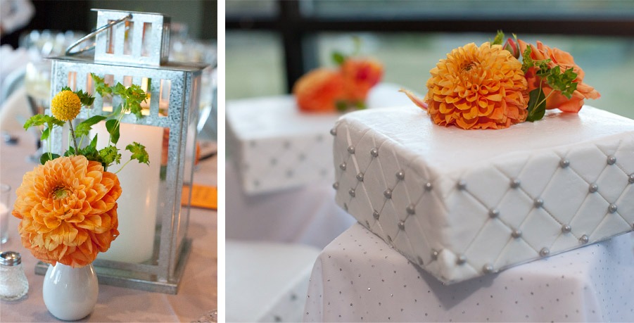 white candles and orange flowers decorate a table--orange flowers decorate a white wedding cake