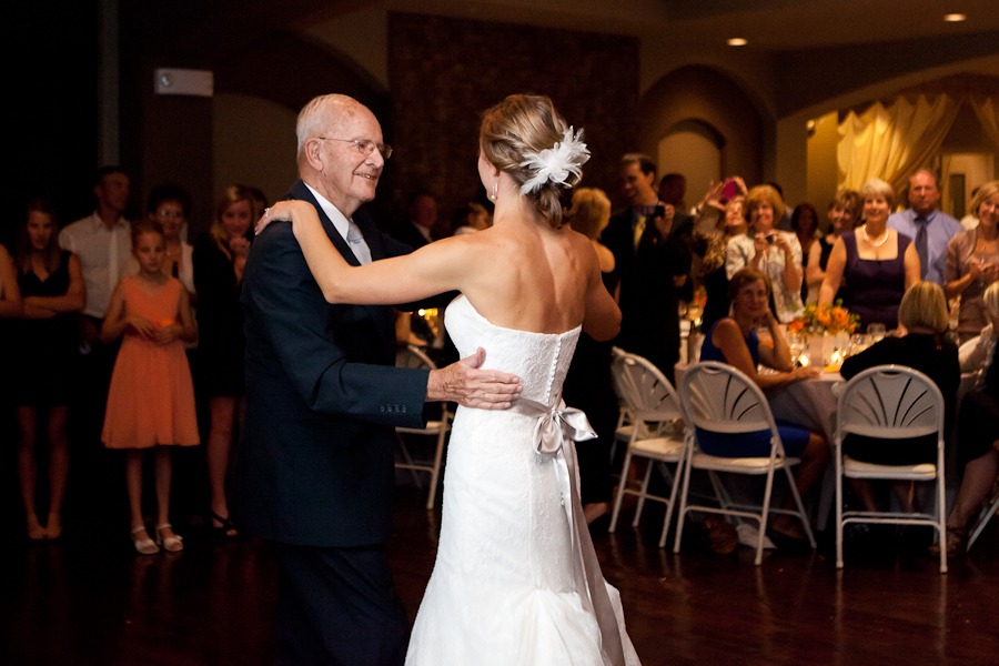 a grandfather dances with his granddaughter, the bride