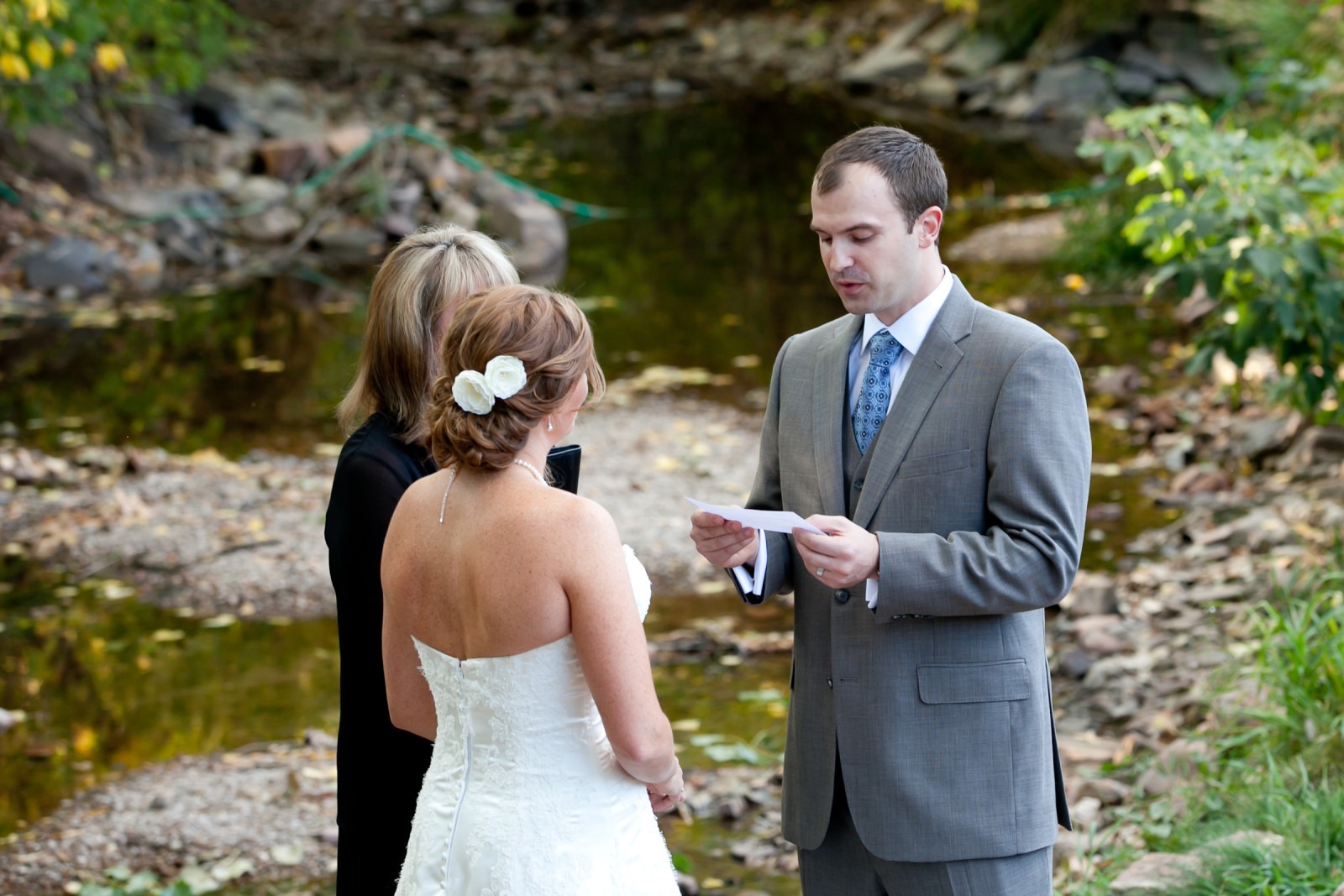 a man reads his wedding vows to his bride