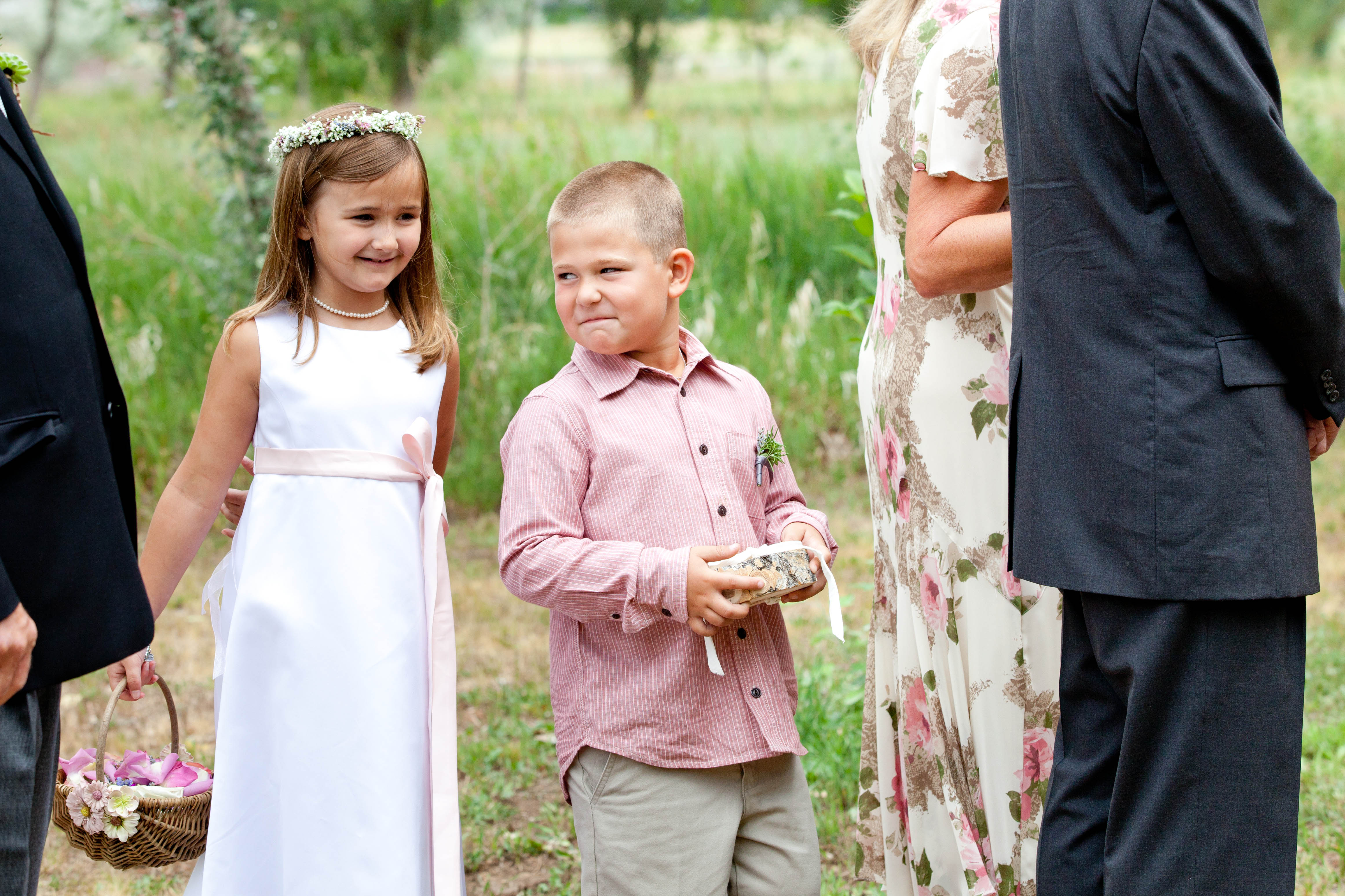 ring bearer makes funny face at flowergirl