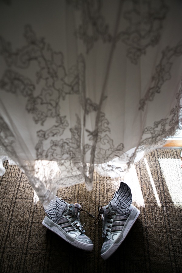 adidas with wings under a wedding dress