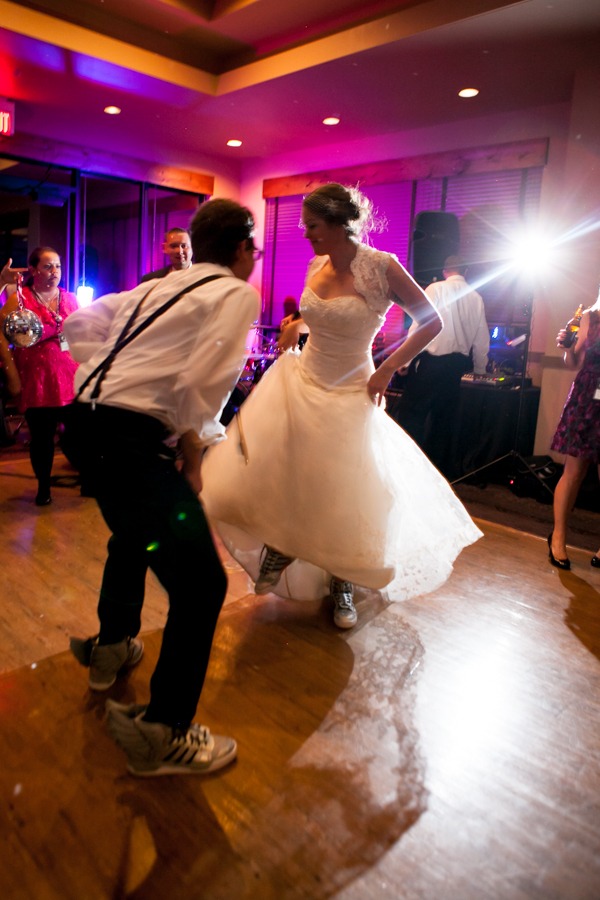 a bride and groom boogie down while wearing crazy adidas sneakers