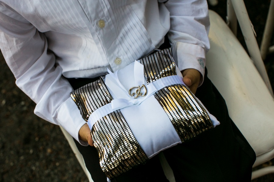 a ring bearer holds a shiny pillow