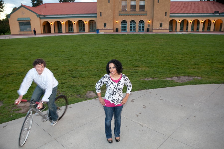 a man rides his bike around a woman at a park in this long exposure photo