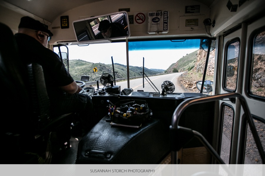 a bus drive drives a bus up a mountain road