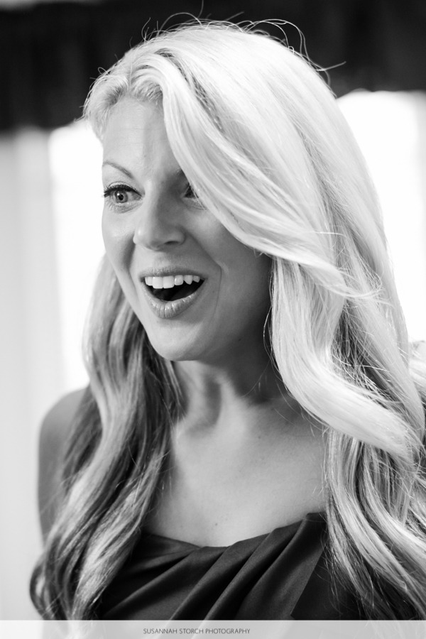 black and white photo of a blonde woman looking happy and in awe