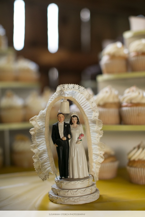 a wedding detail showing an old-fashioned cake topper of a bride and groom
