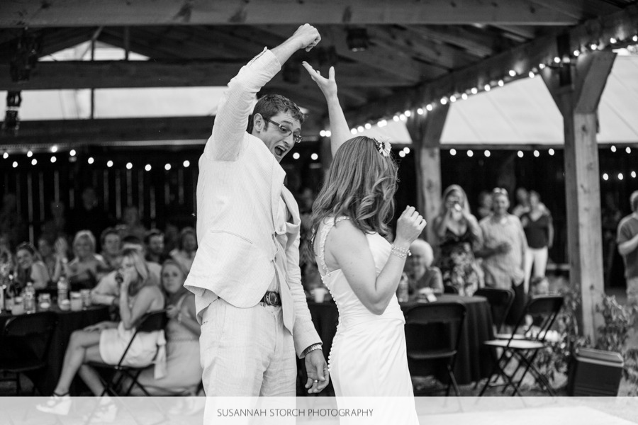 black and white of a groom spinning his bride during the first dance
