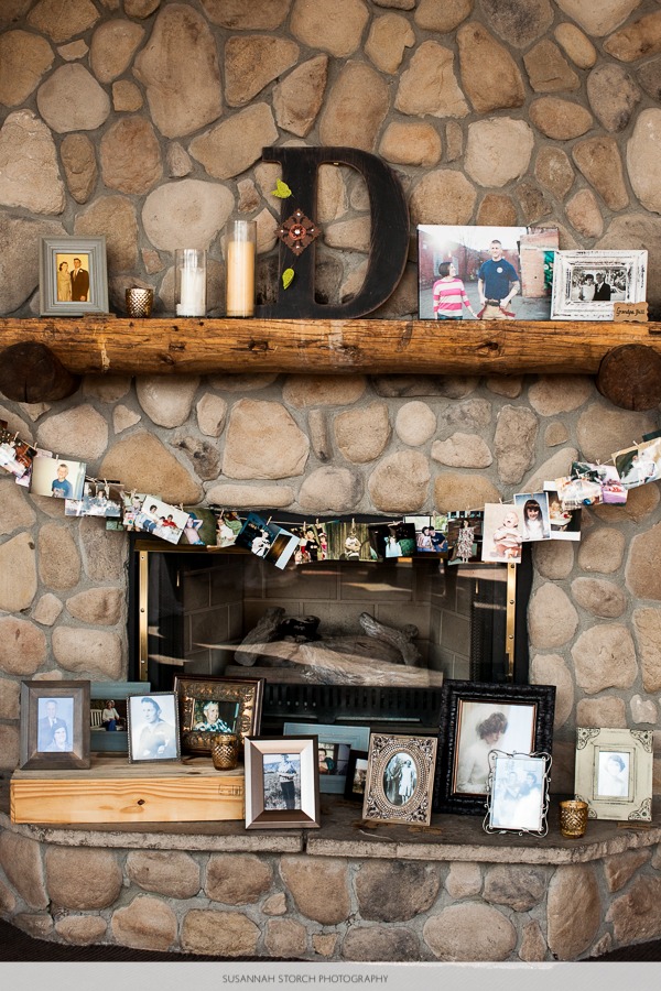 photos decorate a big stone fireplace