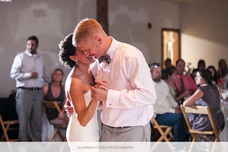 a bride and groom whisper to each other during their first dance