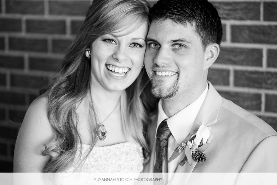 black and white photo of a bride and groom smiling