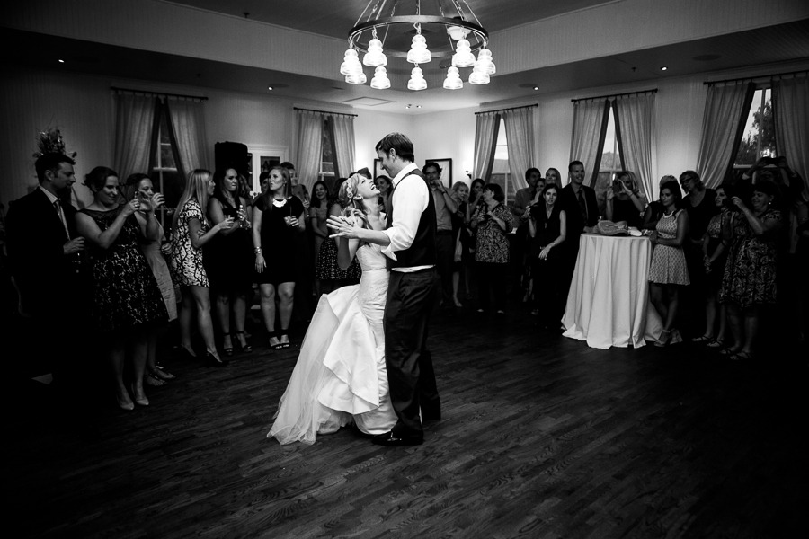 a bride and groom dance in front of wedding guests