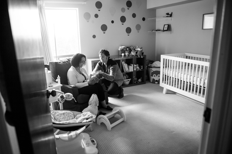 black and white image of parents in a nusery