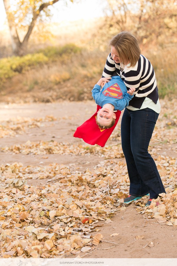 a mon hangs her superman toddler boy upside down