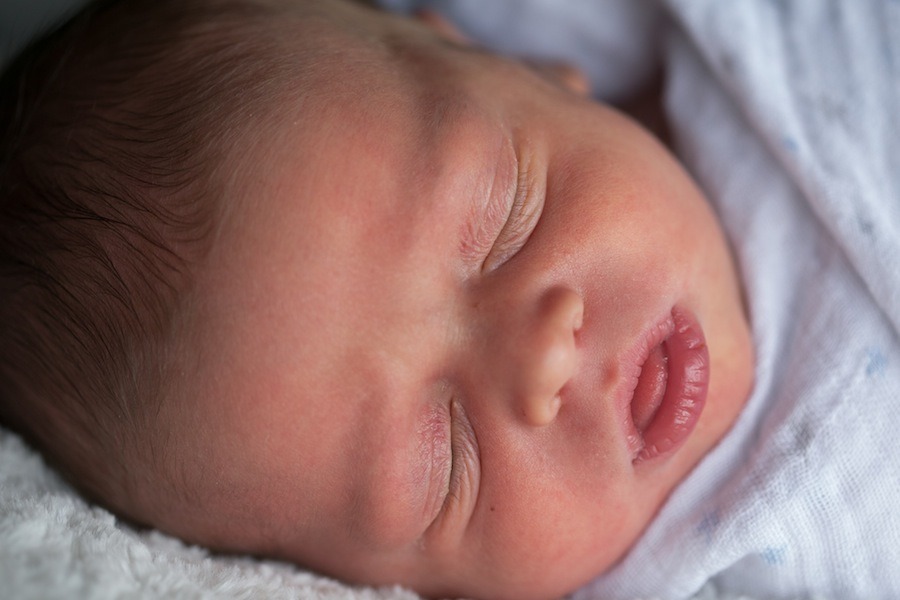 a newborn baby with closed eyes