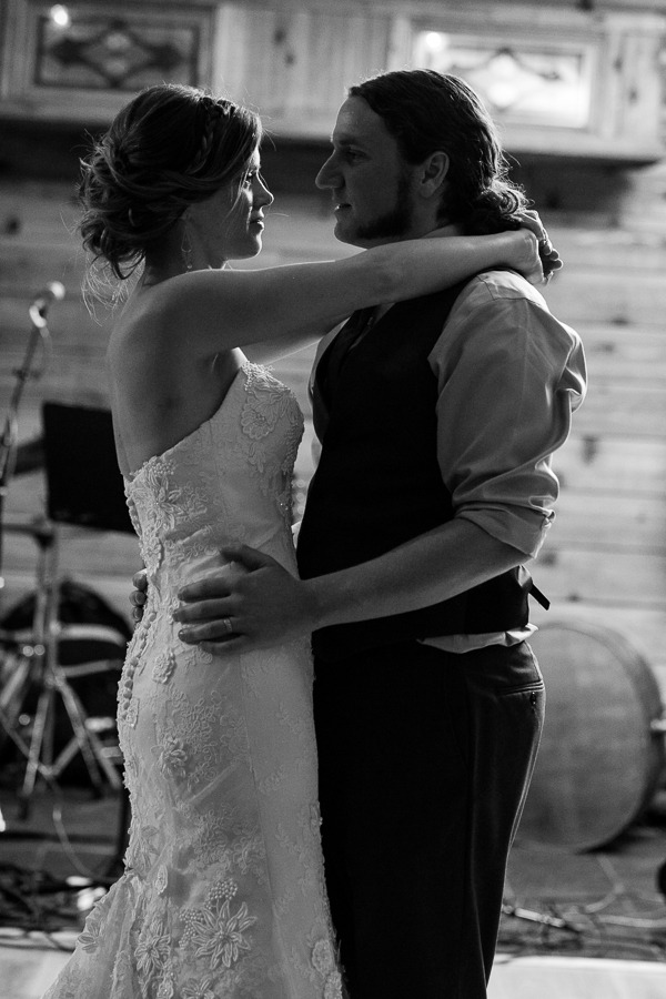 black and white photo of a bride and groom slowdancing