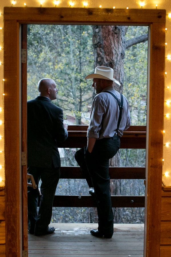 two men talk while standing outside