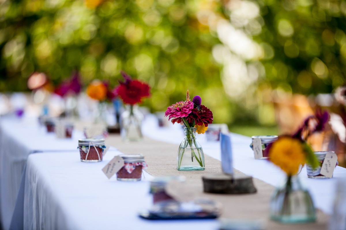 flowers in a vase decorate a banquet table
