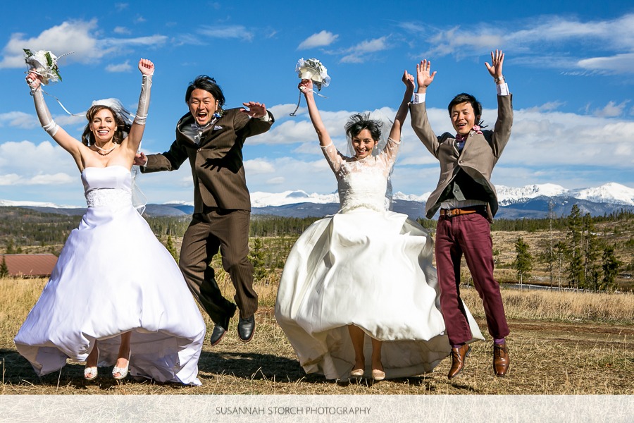 two wedding couples jump up in the air