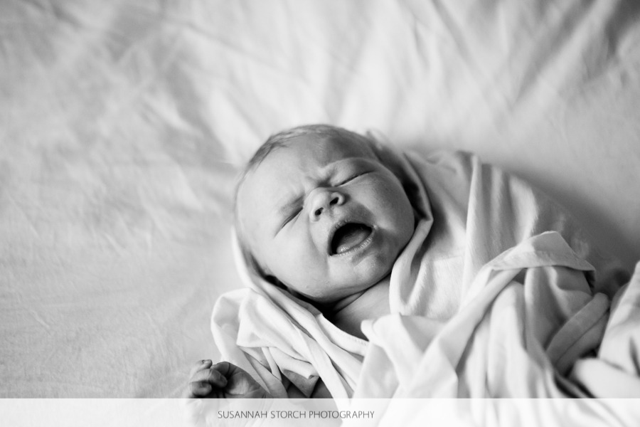 a crying black and white photo of a baby
