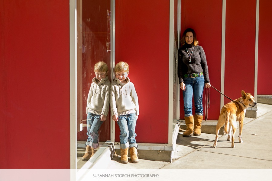 photo of son and mom near a red wall