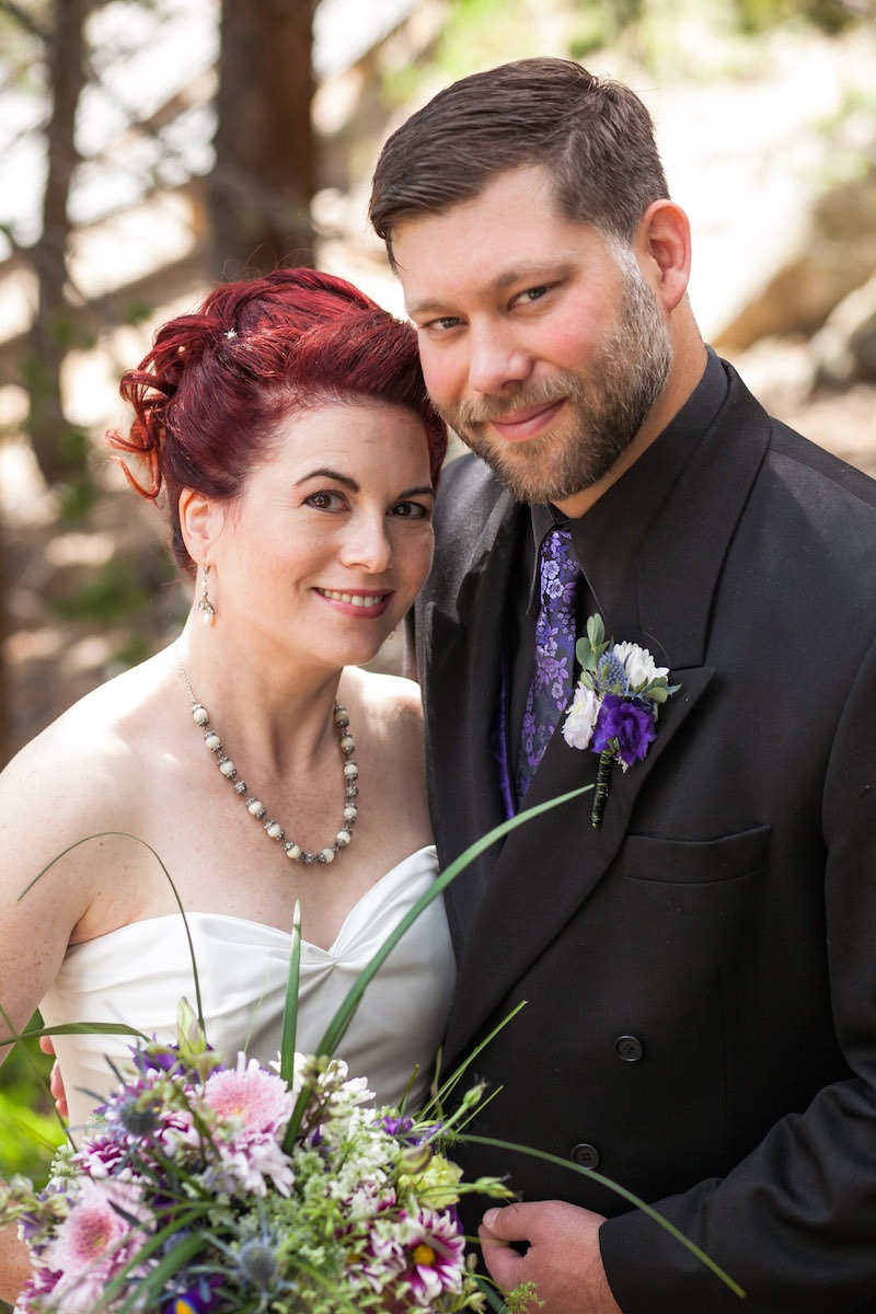 portrait of a bride with red hair and a groom with a purple tie