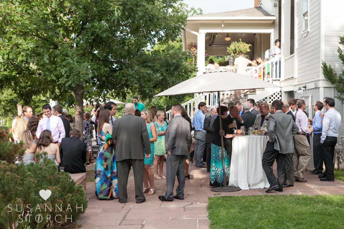 wide angle photo of guests chatting on an outdoor patio