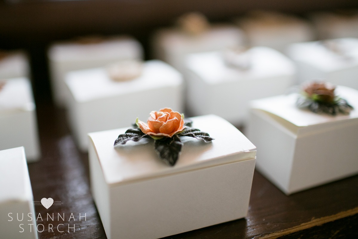 paper flowers are glued on top of white card board boxes