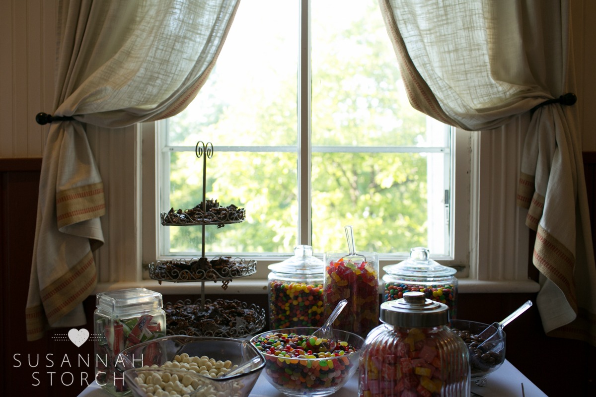 a display of candy in bowls and containers in front of a window