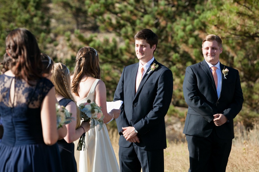 a groom looks at his bride during their outdoor wedding ceremony