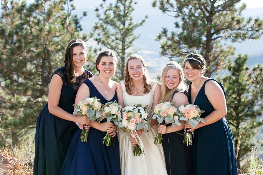 a bridal party lines up with their bouquets