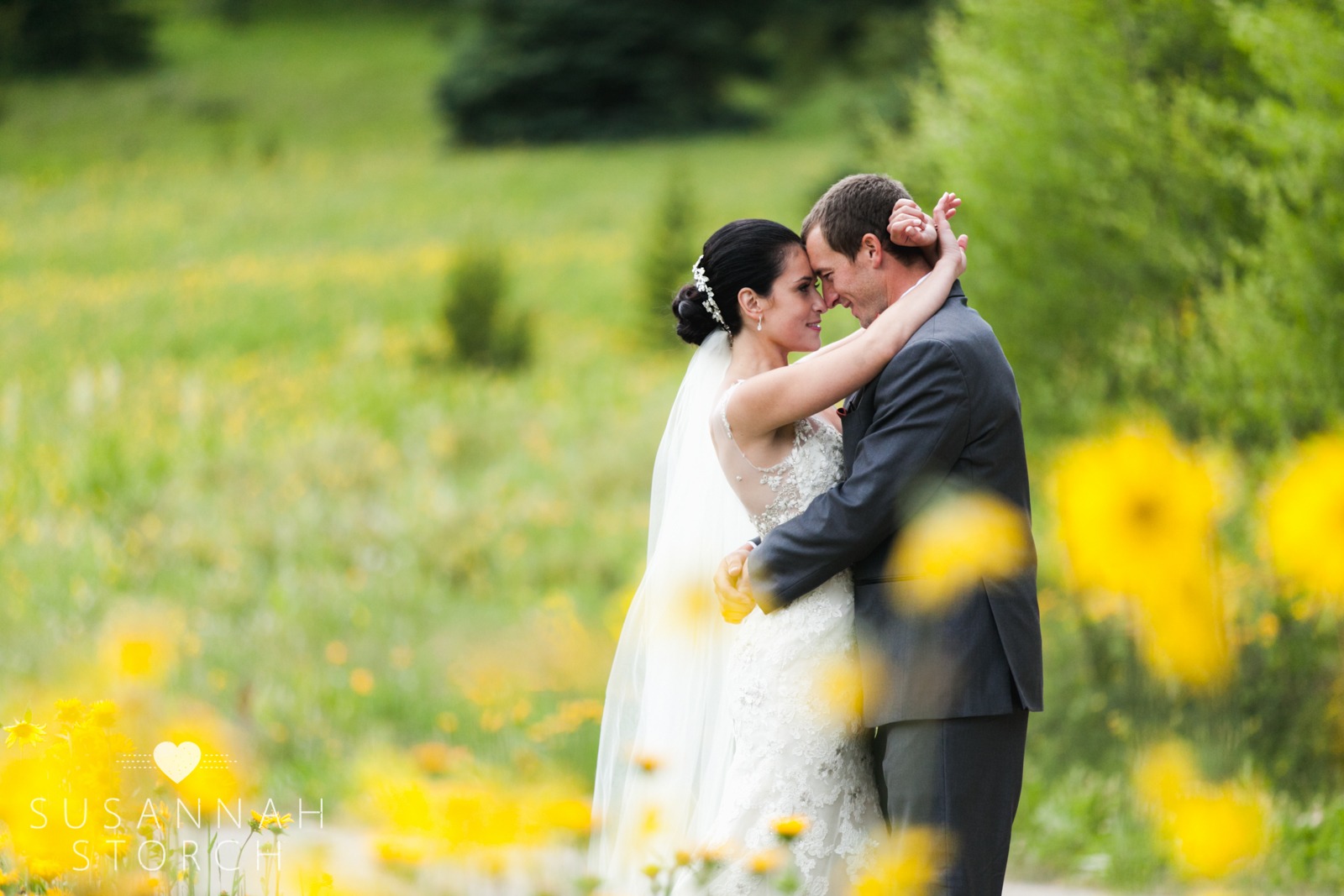 a bride and groom touch noses as they gaze at each other