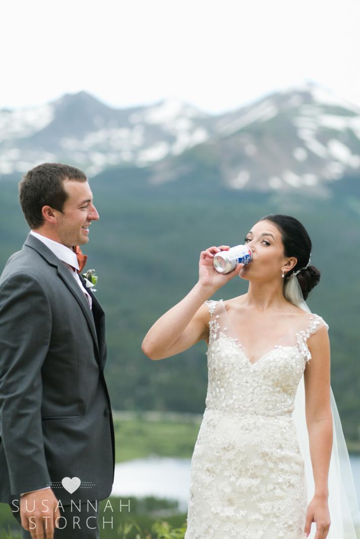 a bride chugs a PBR while her groom watches