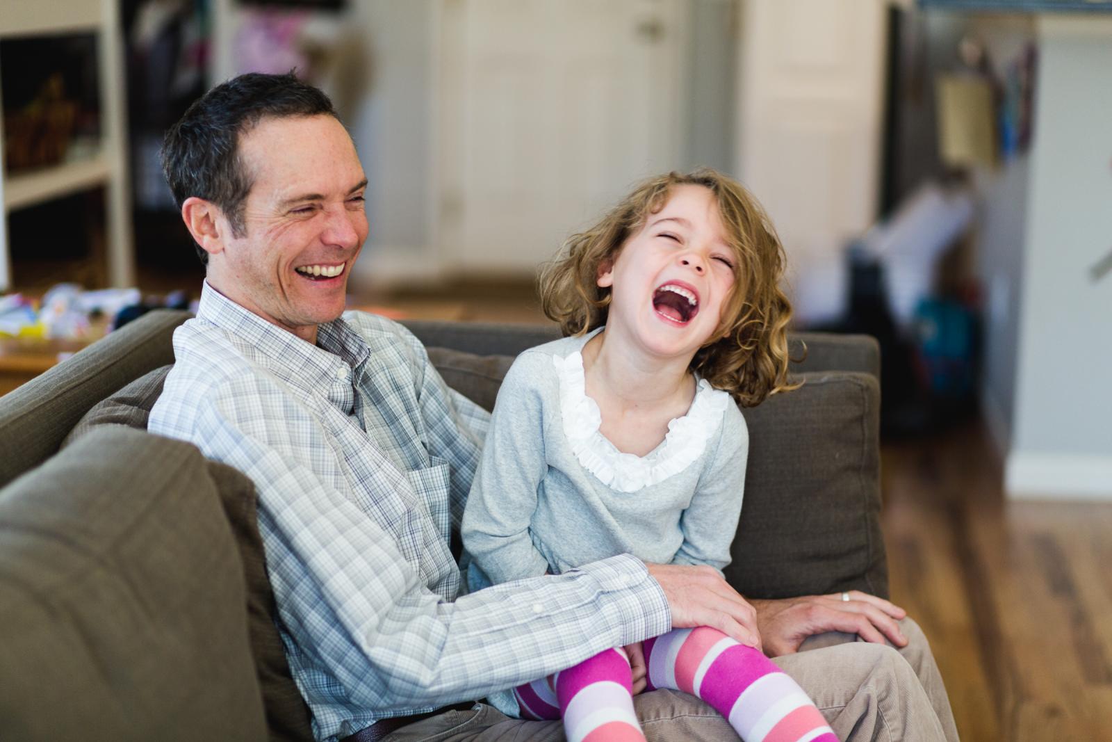 Niwot Colorado in-home family photo session with dad and daughter laughing