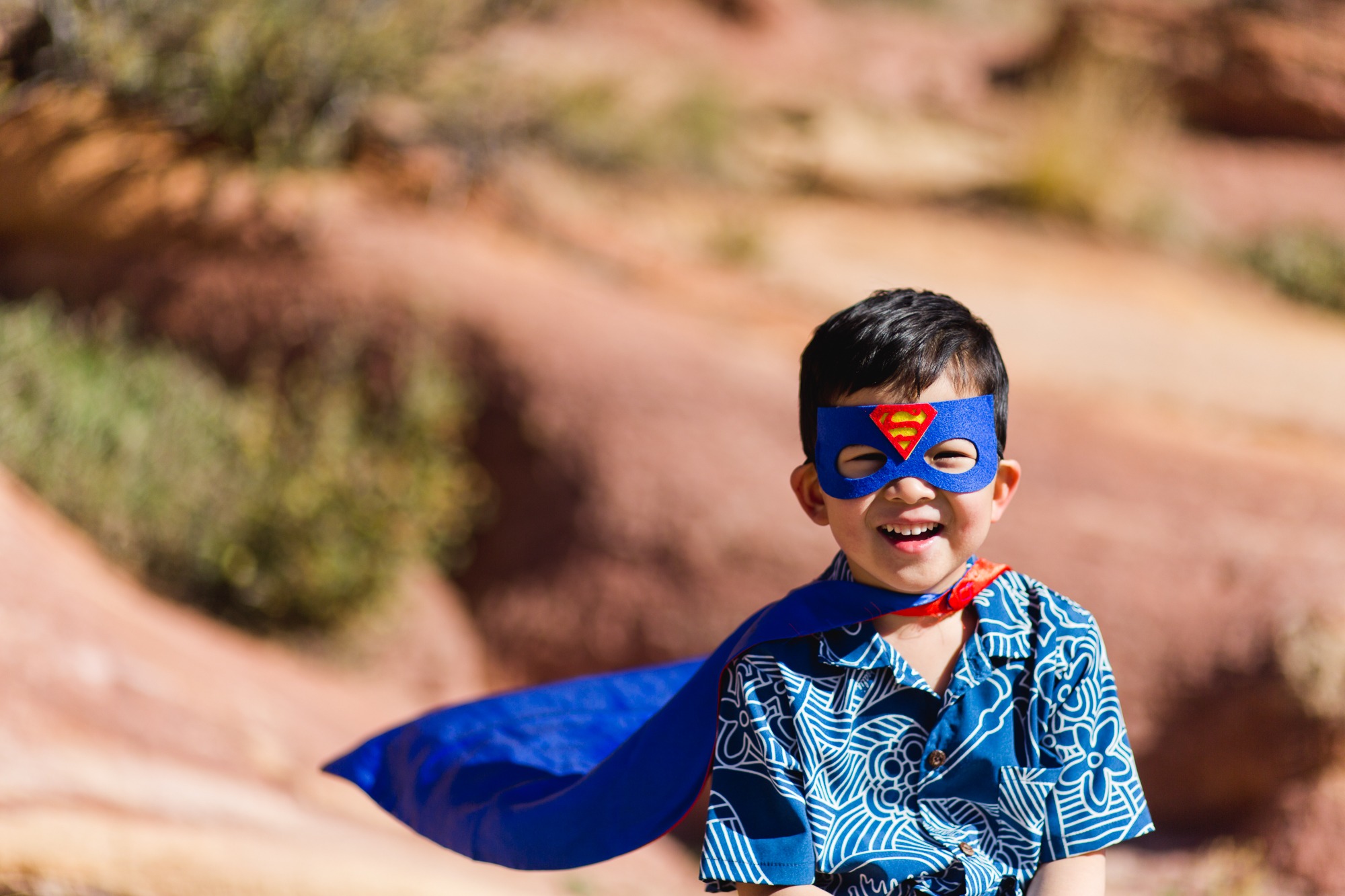 Boy in Super Hero outfit at Red Rocks park in Colorado
