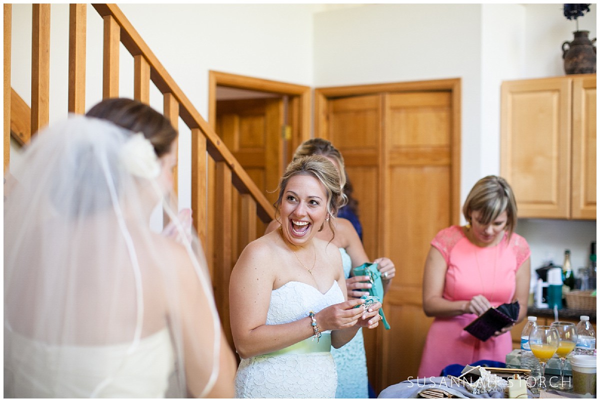 a bridesmaid laughs as she gets ready for a wedding